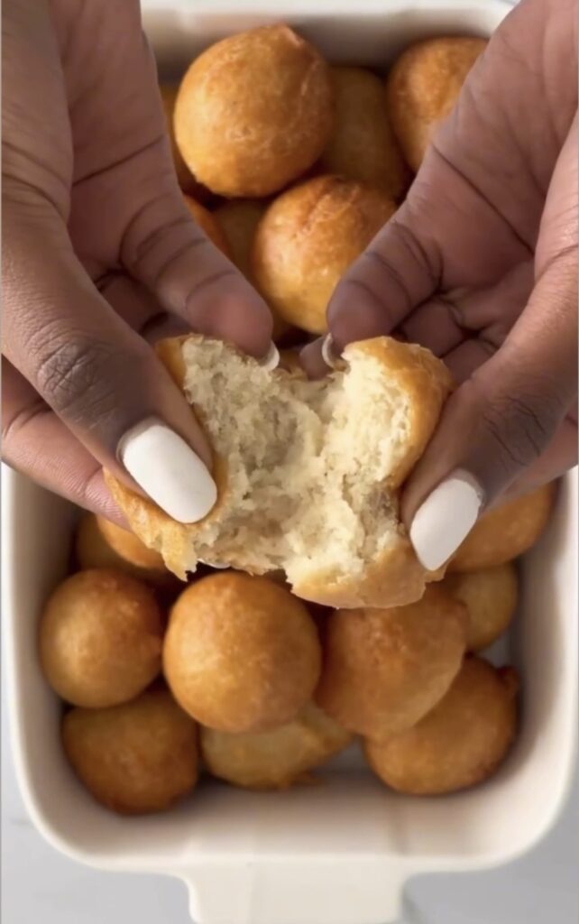 opening-a-fluffy-fried-dough-with-hand
